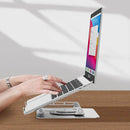Aluminum laptop stand iStand ergonomically elevating laptop for comfortable work position.